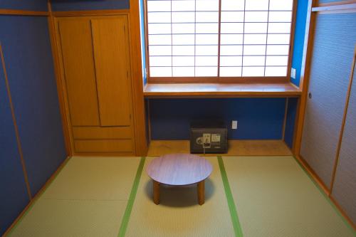 a small room with a table and a window at root hakone in Hakone