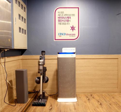 a camera on a table next to a desk with a sign at Anire in Busan