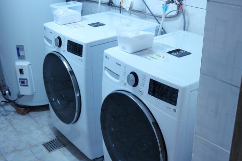 two washing machines sitting in a laundry room at Anire in Busan