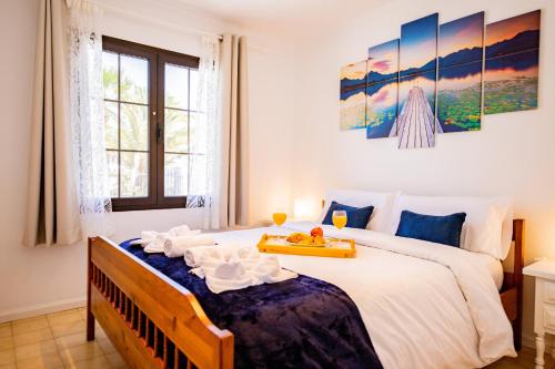 a bedroom with a large bed with a tray on it at Penthouse Ocean View Puerto del Carmen in Puerto del Carmen