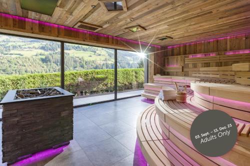 a sauna with a view of the mountains at Hotel & Spa Sonne 4 Sterne Superior in Kirchberg in Tirol