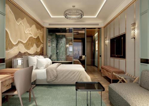 a bedroom with a bed and a desk and a couch at La Passion Hanoi Hotel & Spa in Hanoi