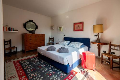 a bedroom with a blue bed and a rug at Agriturismo Terre Bianche in Teolo