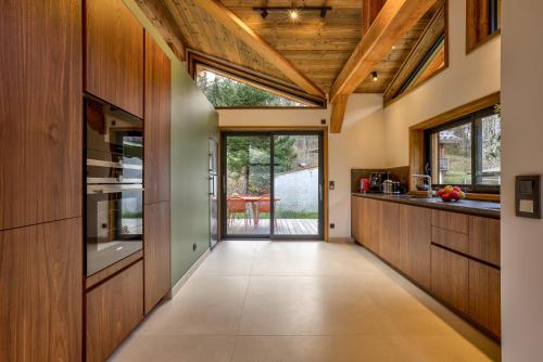 a hallway with wood paneling and a ceiling with windows at Chalet Green Forest in Chamonix-Mont-Blanc