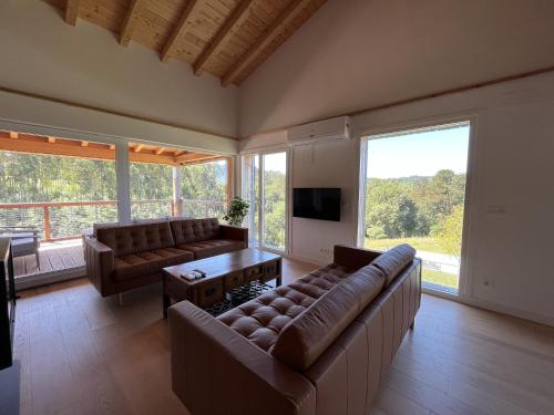 a living room with two couches and a television at Basoan in Mungia
