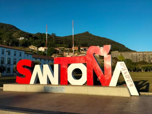 a large sign that says santana in front of a city at Apartamento Virgen del Carmen in Santoña