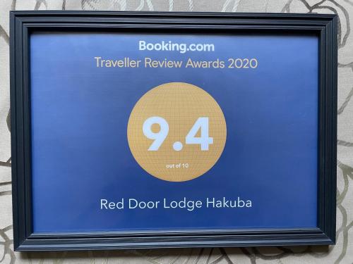 a framed picture of a red door lodge haloda at Red Door Lodge Hakuba in Hakuba