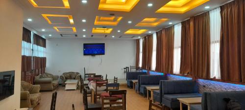 a waiting room with couches and chairs and a tv at Obelisk Hotel Axum in Āksum