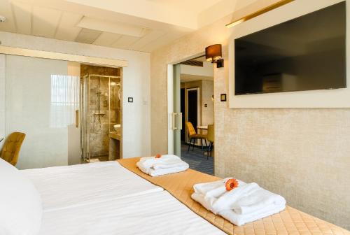 Park Hotel Diament Wroclaw في فروتسواف: غرفة في الفندق مع وجود منشفتين على سرير