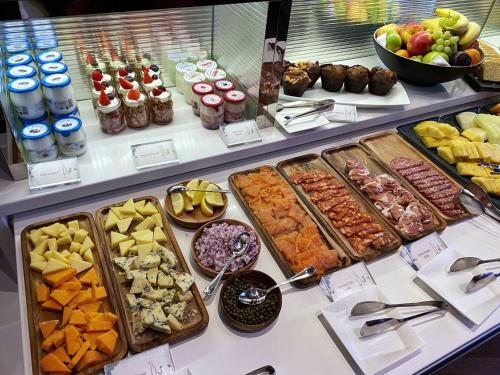 a buffet filled with lots of different types of food at Taj 51 Buckingham Gate Suites and Residences in London