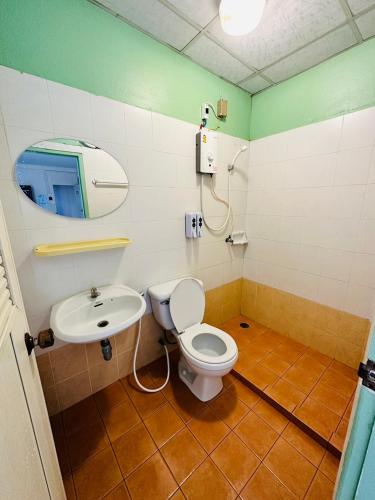 a bathroom with a toilet and a sink at VK &Residence in Kanchanaburi City