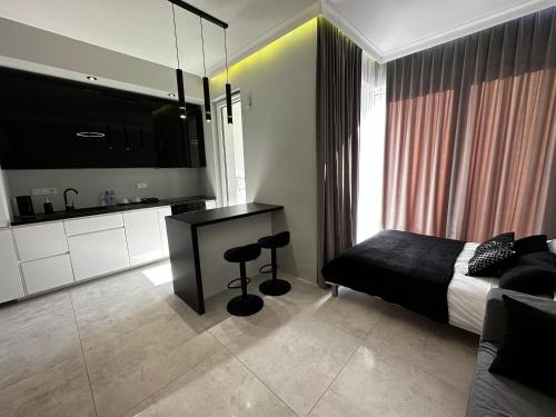 a bedroom with a bed and a flat screen tv at Platinium de lux apartament in Warsaw