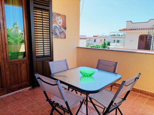 a table and chairs on a balcony with a view at Villemar in Isola delle Femmine