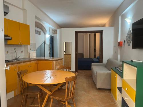 a kitchen and living room with a table and a couch at La Dimora del RE in Gaeta