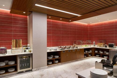 a large kitchen with red walls and wooden cabinets at Residence Inn by Marriott Washington Downtown/Convention Center in Washington, D.C.