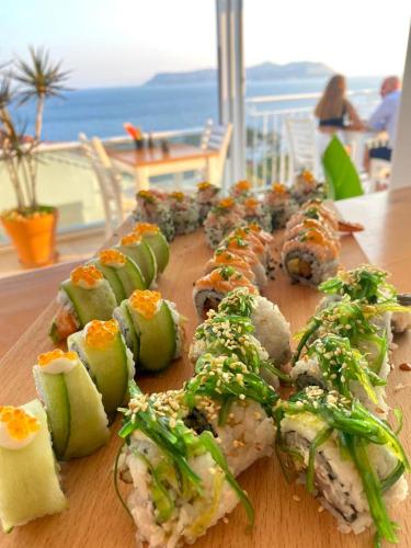 a bunch of sushi on a wooden cutting board at Hideaway in Kas