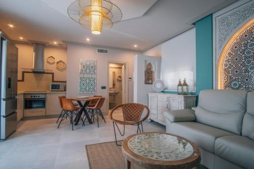 a living room with a couch and a table at Apartamentos Turísticos La Baílla in Rota