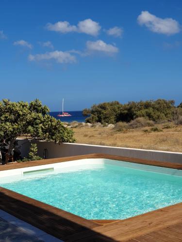 a swimming pool with a view of the ocean at Sea breeze houses in Monolithos