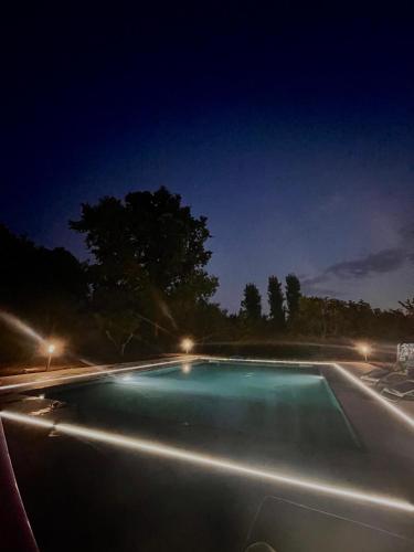 a swimming pool at night with lights on it at Nakupenda Relais in Latina