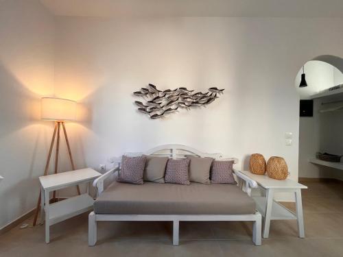a living room with a couch and a lamp at Sea breeze houses in Monolithos