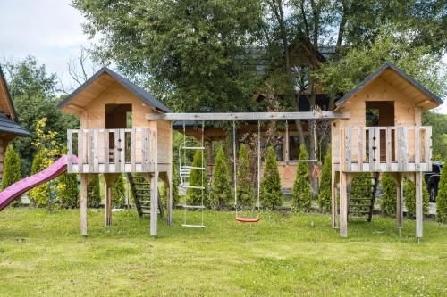 a playground with two swings and a house at Stylowa Chata in Zakopane