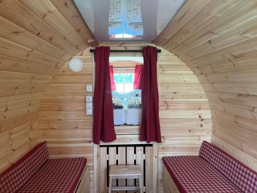 a small room with two beds and a window at Camping u Kukačků in Horní Planá