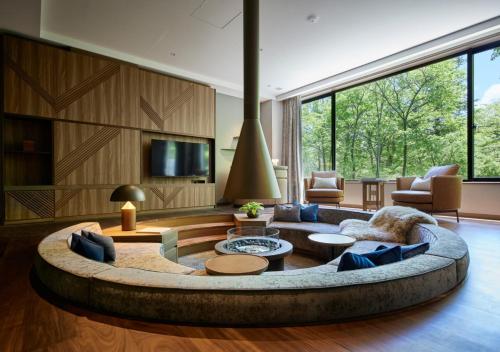 a large living room with a large circular couch at Fufu Kyu-Karuizawa Seiyou No Mori in Karuizawa