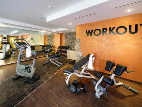 a gym with exercise equipment in a hotel room at Posthotel Walhalla Regensburg Ost in Donaustauf