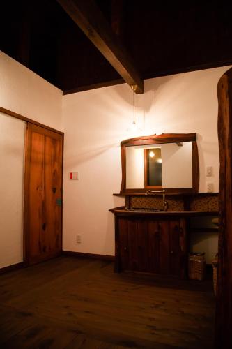 a room with a mirror and a wooden door at Nikko Akarinoyado Villa Revage in Nikko