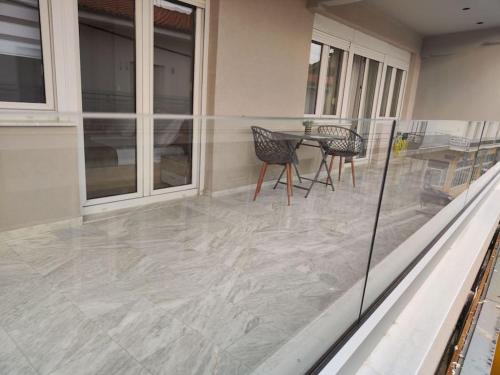 a patio with a table and chairs on a house at Luxury Apartments Deskati A1 in Deskáti