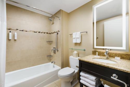 a bathroom with a tub and a toilet and a sink at Fairfield Inn & Suites by Marriott New York Midtown Manhattan/Penn Station in New York