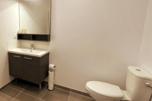 a bathroom with a toilet and a sink and a mirror at Esprit du Sud - Terrasse & Parking in Brignoles
