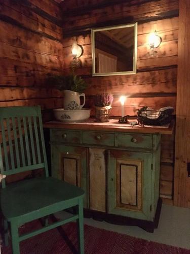a wooden kitchen with a sink and a chair at Savikulma B&B in Mynämäki
