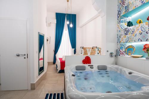 a bathroom with a tub in the middle of a room at PALAZZO NICOLAUS del BORGO ANTICO in Bari