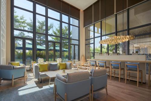 a lobby with tables and chairs and a bar at Element Xiamen Tong'an in Xiamen