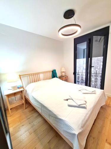 um quarto com uma grande cama branca e uma janela em PROMENADE SEA SIDE APARTMENT em Herceg Novi
