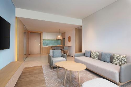 a living room with a couch and a table at Element Xiamen Tong'an in Xiamen