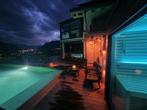 a house with a swimming pool at night at Bella Flocon appartements min 2 Nights Special weekly and monthly prices in Savièse