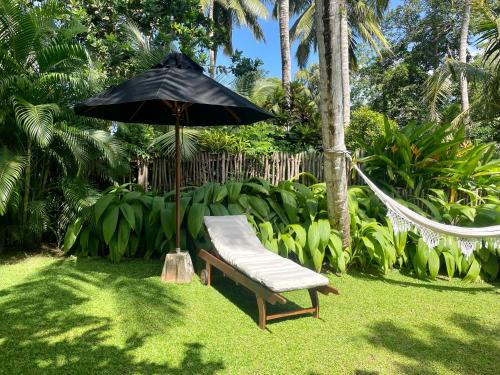 a hammock and an umbrella in a garden at Kanferri Villa in Ahangama