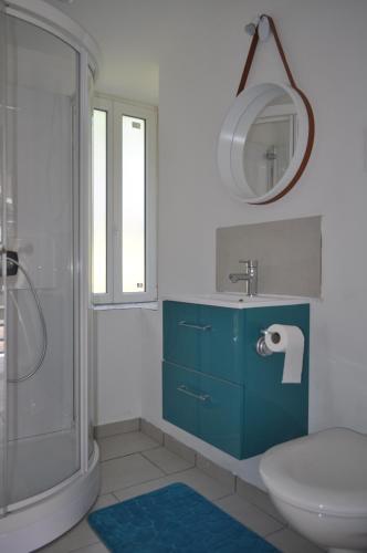 a bathroom with a toilet and a sink and a shower at Creusoé in Saint-Marc-à-Frongier