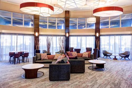 a lobby with couches and tables and windows at Courtyard by Marriott Franklin Cool Springs in Franklin