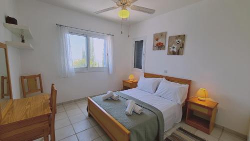 a bedroom with a bed with two towels on it at STAY Tala Sea View Apartment in Tala