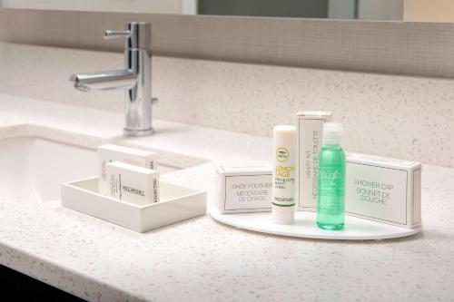 a bathroom counter with hygiene products on a sink at Residence Inn by Marriott Denver Airport/Convention Center in Denver