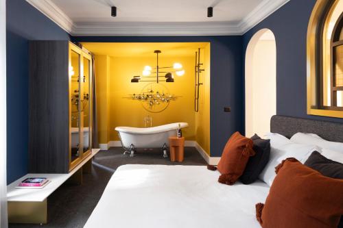 a bedroom with a bathroom with a tub and a bed at Oborishte 63,The Art Boutique Hotel by Sandglass in Sofia