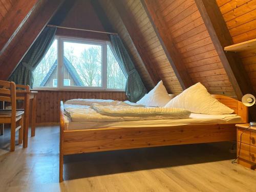 a bed in a room with a window at Ferienpark Fedderwardersiel in Fedderwarderdeich