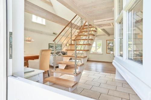 a staircase in a home with a living room at Reetdachhaus Haubarg-Kieker in Simonsberg