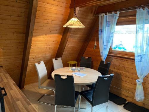 a dining room with a table and chairs at Ferienpark Fedderwardersiel in Fedderwarderdeich