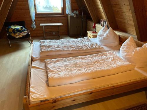two twin beds in a room with a window at Ferienpark Fedderwardersiel in Fedderwarderdeich