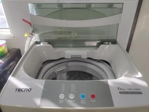 a washing machine with its door open in a room at Homestay Batu Pahat, BUSHRA in Batu Pahat