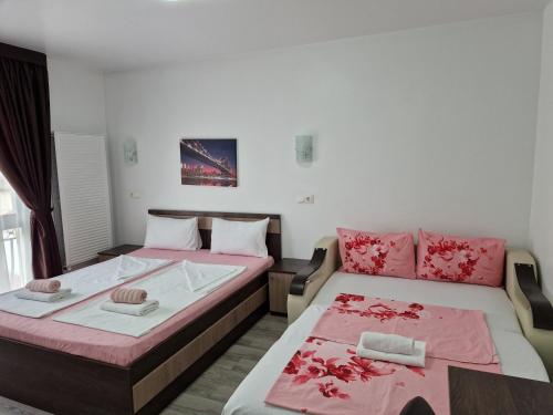 a bedroom with two beds and a couch at Bella Vista Turda in Turda